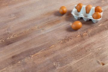 Fresh eggs on wood background. Copy space. Top view