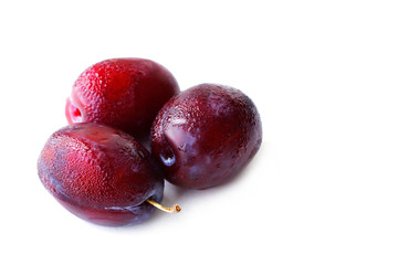 Ripe plums on white background