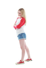 full length portrait of a blonde girl wearing casual t-shirt and denim shorts. isolated on white background.