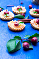 Apple caramel little tarts on blue rustic background. French tatin with paradise apple