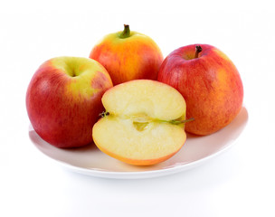red apple in white plate isolated on white background