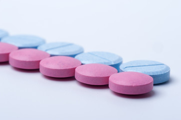 Obraz na płótnie Canvas Macro shot of blue and pink medicine pills