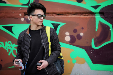 Asian young man on the street posing at the camera