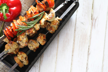 Kebab cooked on metal skewers with vegetables