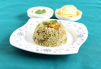 Homemade rice pilaf, a popular and traditional Indian food, made from rice and vegetables like carrot, capsicum and peas.