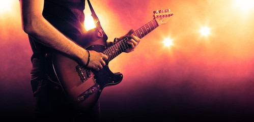hand of a guitar player playing a guitar - obrazy, fototapety, plakaty