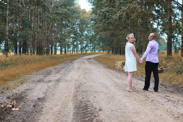 Fototapeta premium Just married lovers walking in a field in autumn day