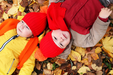 kids in autumn park with pumpkin