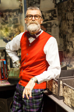 Portrait of quirky vintage senior man in vintage record shop