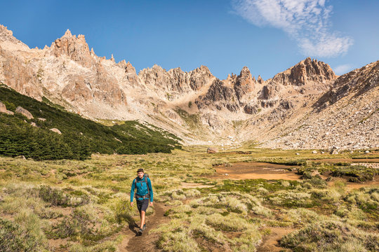 Male hiker trekking in mountain valley, Nahuel Huapi National Park, Rio Negro, Argentina