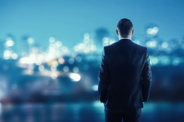 Businessman Looking At Cityscape Through Window