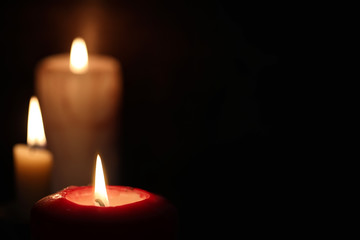 Burning candle flame in the dark