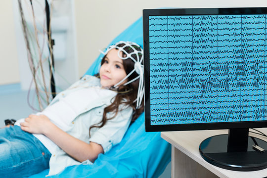 Little girl having her brain waves recorded via electroencephalograph