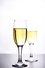 glass of white wine on a table on white background isolate