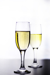 glass of white wine on a table on white background isolate