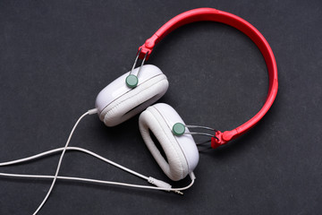 Hobby, leisure and music concept. Headphones in white and red