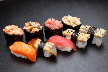 Many different sushi on a black table, Japanese food