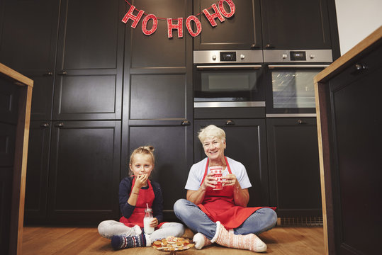 Portrait Of Grandmother And Granddaughter In Kitchen