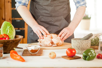male preparing chicken for cooking