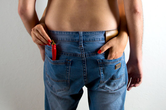 woman gets out of the pocket of the jeans the red pepper