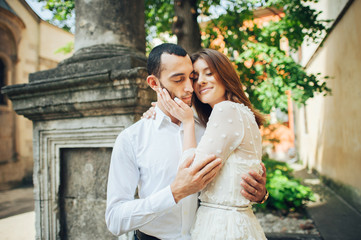 Beautiful young couple in love kissing on the street.