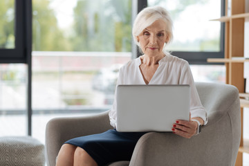 Smart experienced businesswoman working on the laptop