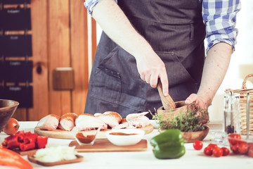 male preparing chicken for cooking