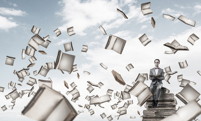 Young businessman or student studying the science and books fly 