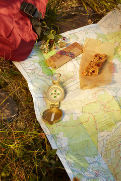 Map, compass and energy bar on grass, close-up, Colgate Lake Wild Forest, Catskill Park, New York State, USA