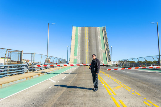 Portrait of worker in front of barrier and drawbridge at biofuel plant