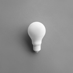 White lightbulb on pastel color background.Ideas creativity,inspiration,concept.Flat lay design.