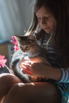 Girl holding kitten