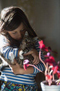 Girl holding kitten