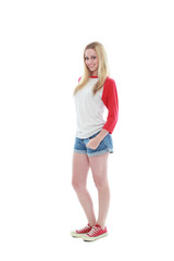 full length portrait of a blonde girl wearing casual t-shirt and denim shorts. isolated on white background.