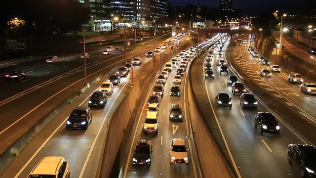 Sydney Warringah Freeway At Night With Heavy Motor Vehicle Traffic Entering The Harbour Tunnel, Harbour Bridge On Multi-lane Highway.