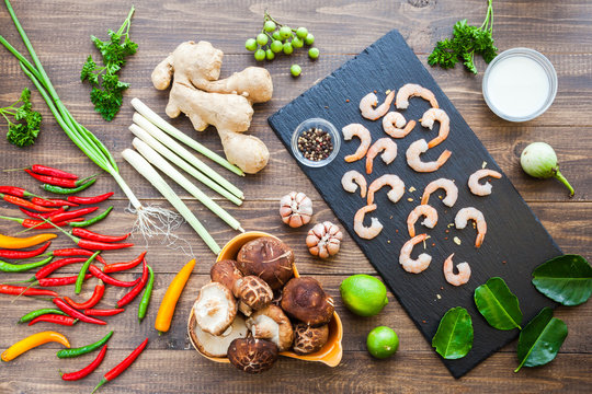 Ingredients for famous thailand spicy hot soup with red chilly peppers, shrimp, lemongrass leaf, shiitake mushrooms, ginger root, coconut milk, garlic and lime. Tom Yum Kung. Asian Dish Cuisine. Top.