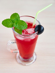 A glass of fruit juice with ice and mint