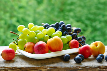 A plate of fruit on a natural floral background