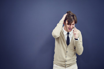 young casual man talking on the phone isolated on white background