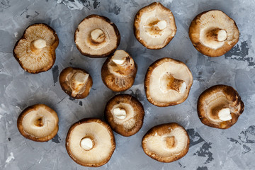 Fresh raw organic Shiitake Mushrooms is cooking ingredient for hot chilly asian soups pn marble stone surface. Healthy vegetarian food. Top view. Kitchen concept. Thailand and Vietnam cuisine.
