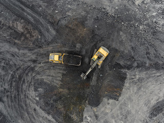 Aerial view open pit mine, loading of rock, mining coal, extractive industry