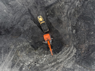 Aerial view open pit mine, loading of rock, mining coal, extractive industry