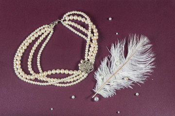 Beadwork, some scattered beads and beautiful feather