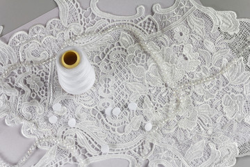 Beautiful white lace and spool of thread