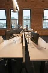 Trendy modern open concept loft office space with big windows, natural light and a layout to encourage collaboration, creativity and innovation