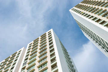 Residential high-rise buildings against blue sky with cloud