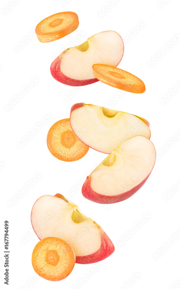 Wall mural isolated cut fruits in the air. falling slices of carrot and red apple isolated on white background 