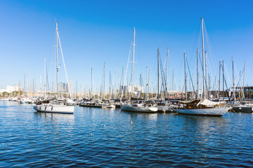 Fototapeta na wymiar Street view of Barcelona harbor with boats, Spain Europe