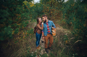 Beautiful young couple in a pine forest