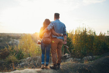 Young happy couple enjoying together in wild mountain river.